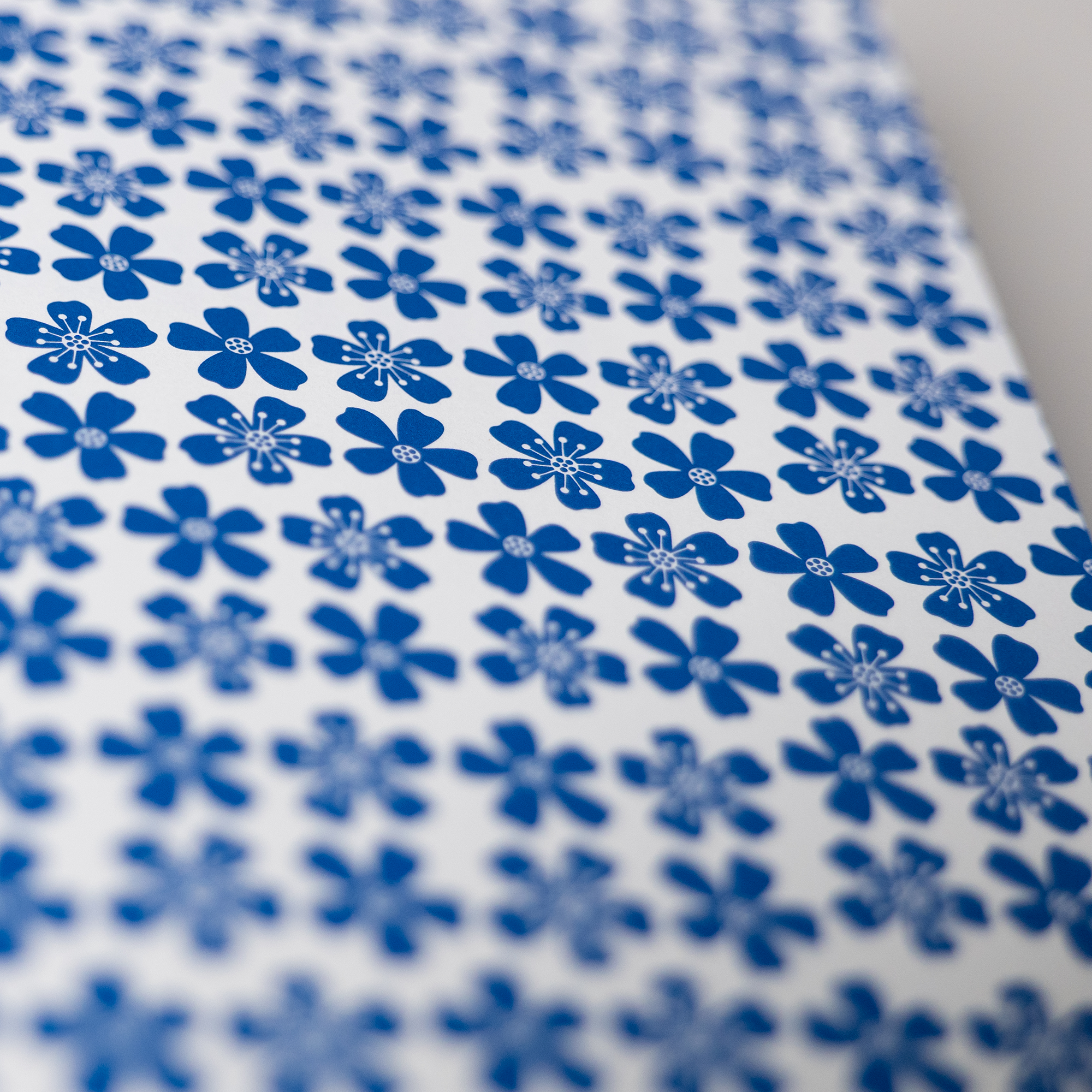 The endpapers, revealing a repeating blue flower pattern.